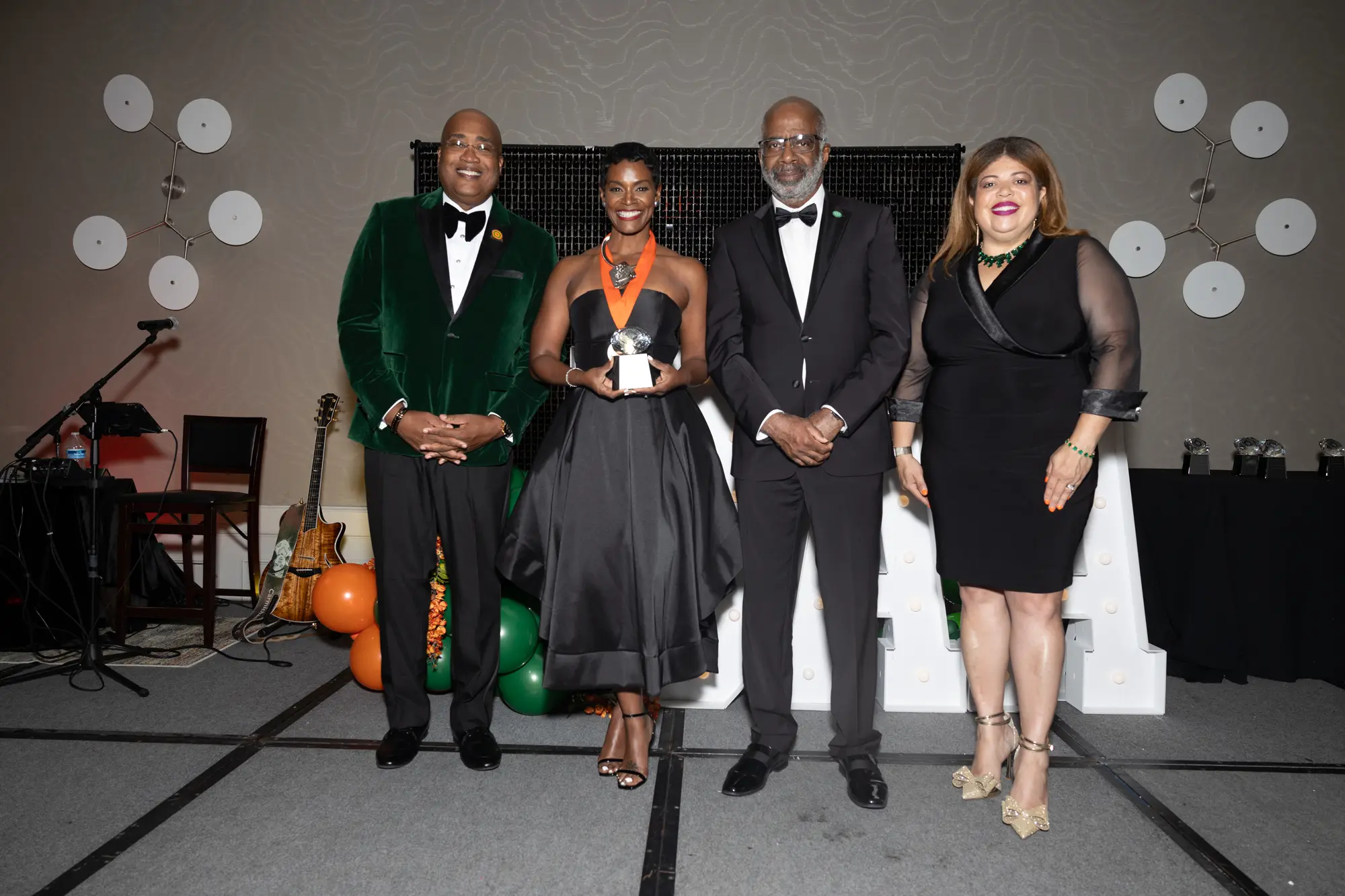 FAMU NAA President Curtis Johnson, Rashan Ali, FAMU President Larry Robinson and FAMU Boad of Visitors Chair Kristin Harper stand together as Ali accepts her award. 