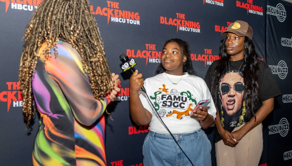 From Left: WANM students Janelle Sears and Jalynn Mcduffey interview Tracy Oliver for the “Streetlights Podcast” at “The Blackening” Film HBCU Tour at the IMX Theater in the Challenging Learning Center in Tallahassee, Florida.