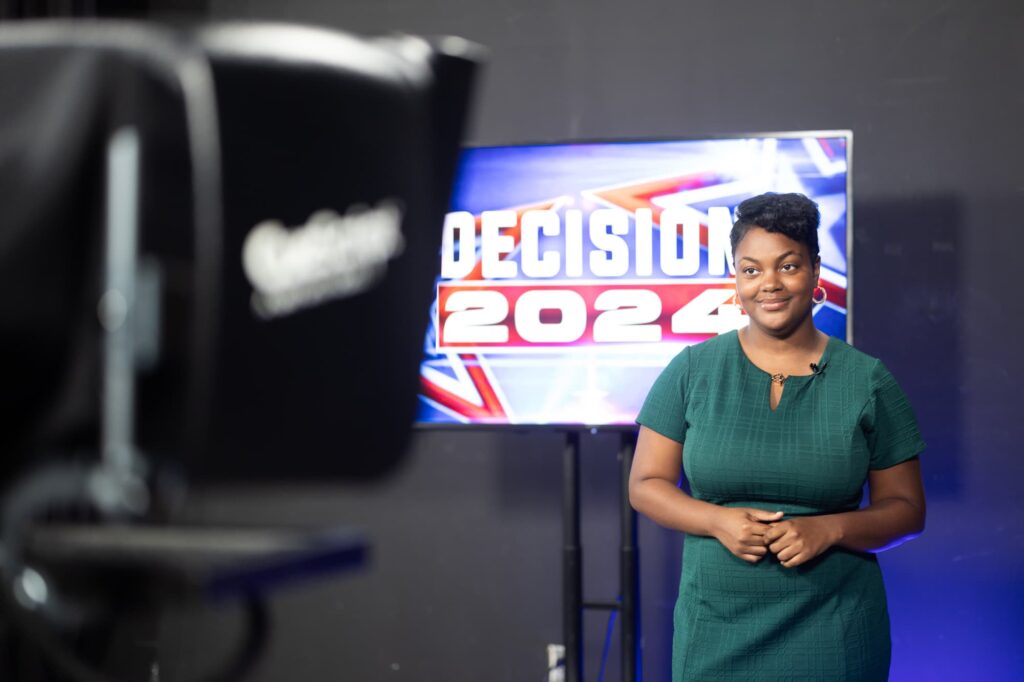 SJGC broadcast student does a standup in the TV 20 studio for Election Night coverage.