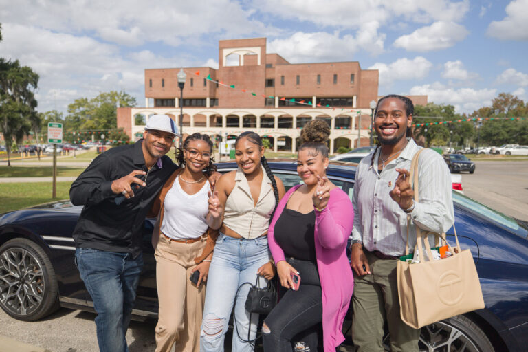 Kimatni D. Rawlins, BAMG founder and publisher of Automotive Rhythms (far left) poses with FAMU students during the 2023 FAMU SJGC Grads Are Back Homecoming event. Hyundai provided the car to be on display during FAMU’s 2023 Homecoming.