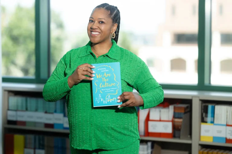 FAMU SJGC Garth C. Reeves Eminent Scholar and digital journalism professor Arionne Nettles poses with her new book, We are the Culture: Black Chicago’s Influence on Everything, which was recently named a finalist in the Chicago’s Reader’s Best of Chicago awards.