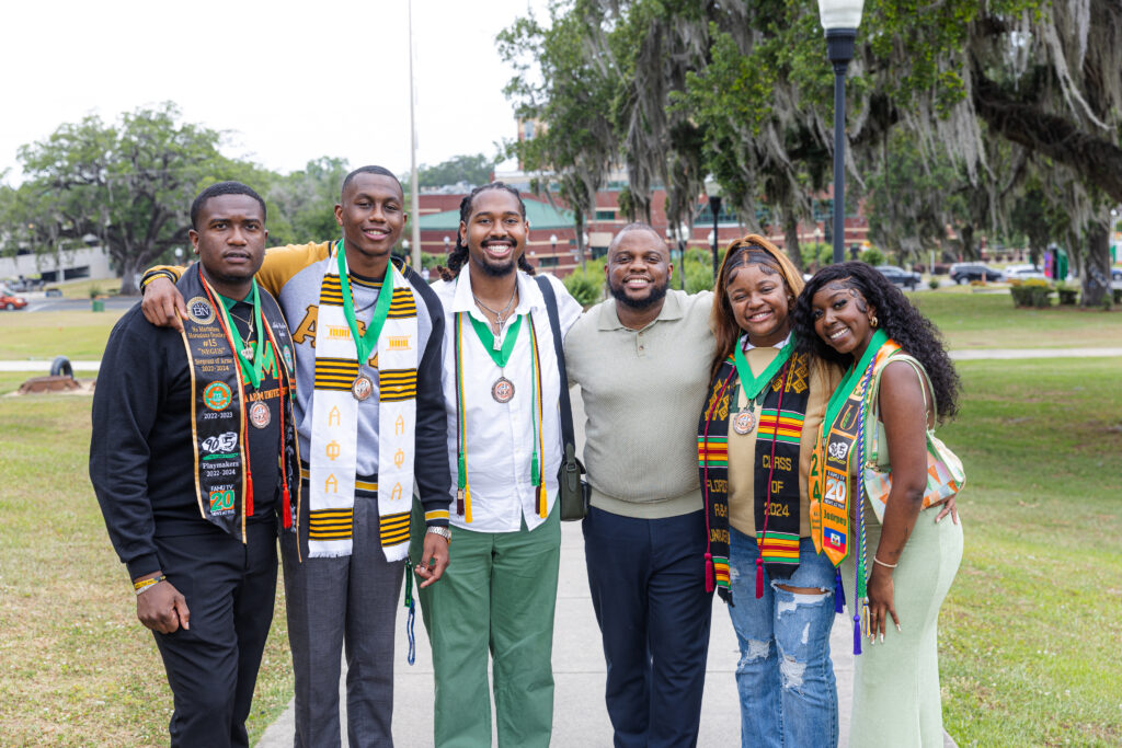 Ward smiles with excitement after seeing his mentees graduate each academic year. He is celebrated across the campus community for encouraging students from their enrollment to their commencement. He is pictured here with several of his WANM student staffers who graduated in 2024.