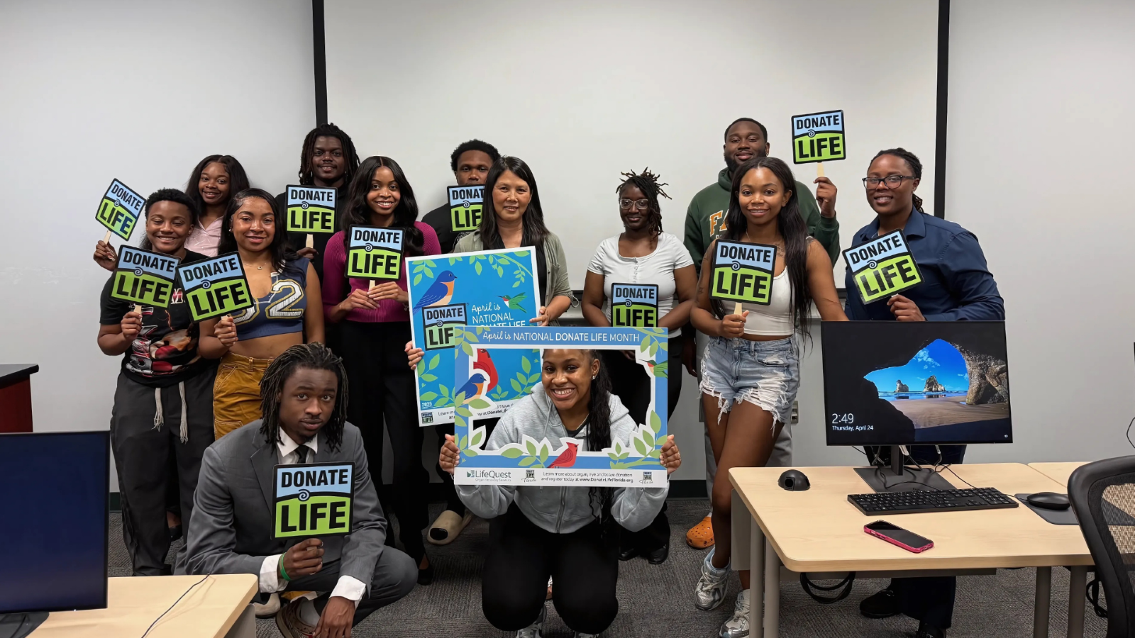 FAMU SJGC Associate Professor Hsuan Huang, Ph.D. (center), celebrates with her students after the success of her class project where students were challenged with developing digital content campaigns to promote organ donation.