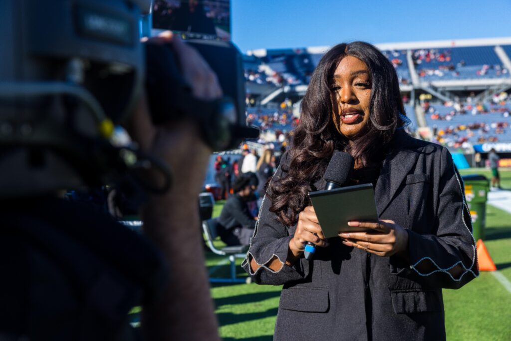 Floyd's love for the HBCU community never keeps her too far from her Rattler family. She is pictured here reporting from the field on a chilly day during the 2024 Florida Classic. Photo: Christian Whitaker