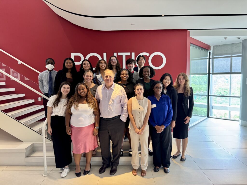 John Harris, co-founder and global editor-in-chief of POLITICO, joins Sears (center right) and her colleagues for their PJI class photo at the iconic newsroom stairwell. 