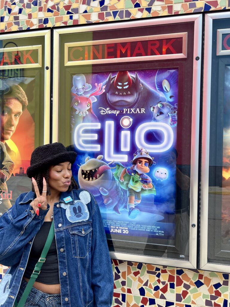 Left: Briana Grant pauses to take a moment to celebrate her contributions to Pixar's Elio, as she sees the movie in theaters. Examples of her initial designs for the alien language featured in the film are seen above. 