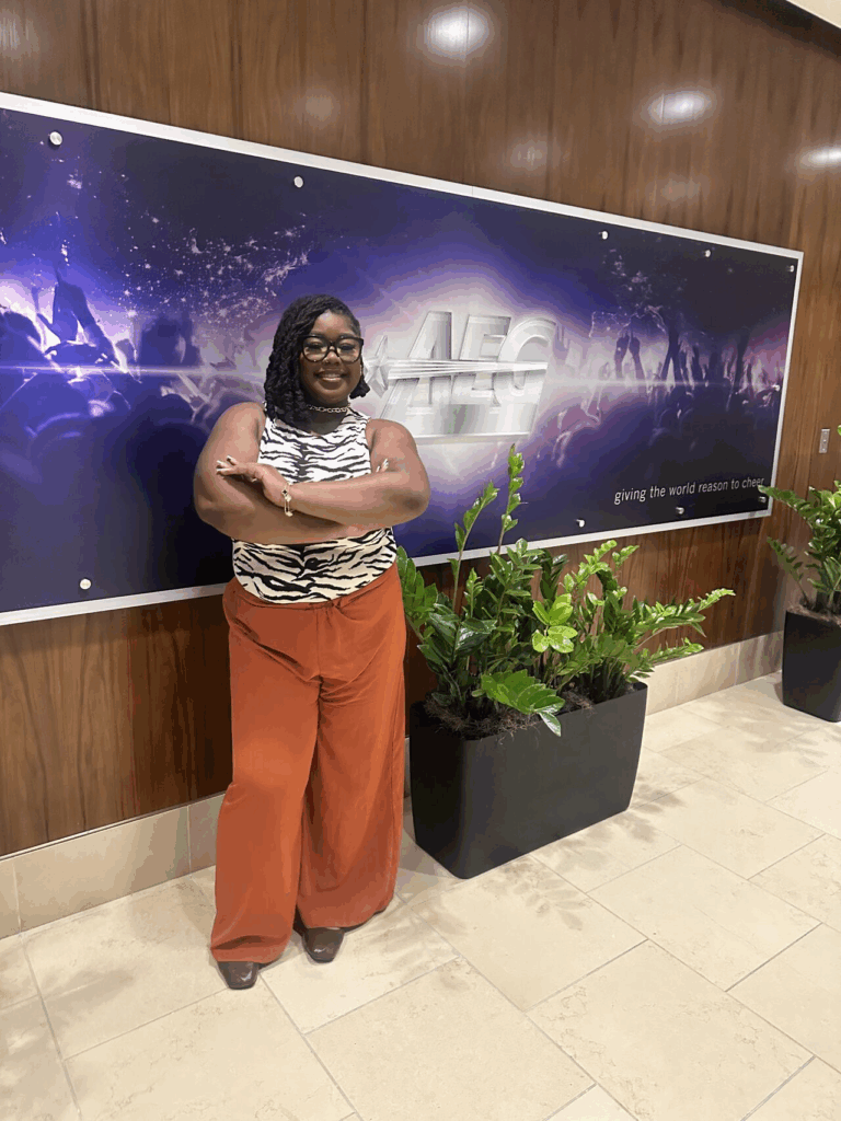 Zaria Salter poses at the AEG headquarters. A sample of her design work for AEG's Crypto.com arena is featured below, which was displayed during the Flagstar Courtside Classic. 
