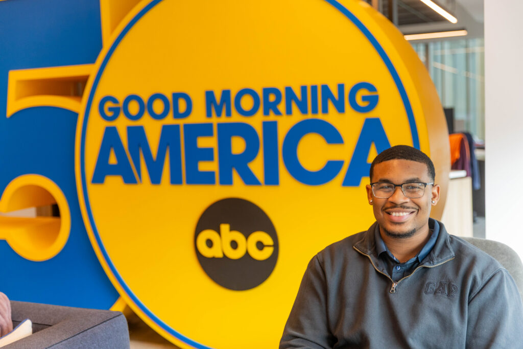 Student in front of GMA sign.
